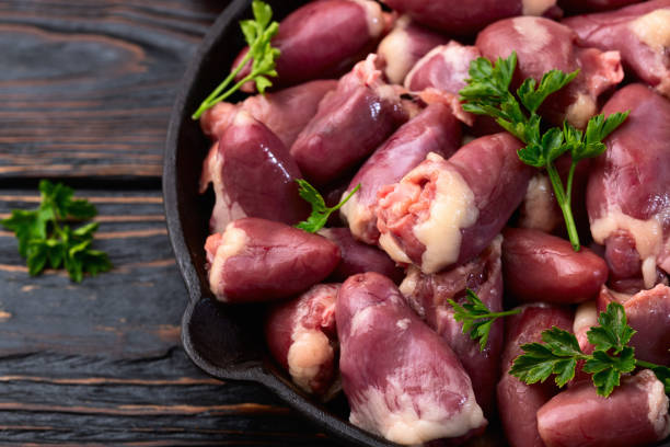 istock Raw chicken giblets hearts , meat background 2165495724