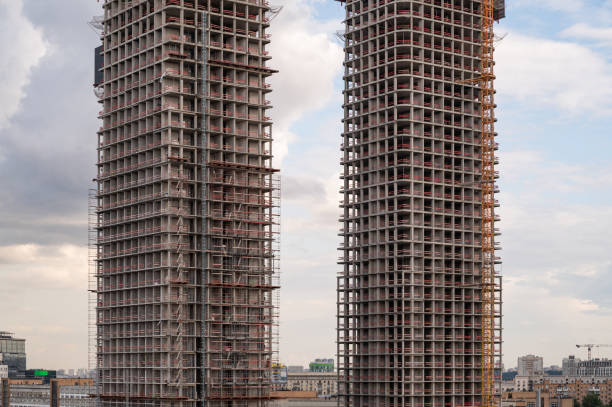 Construction site of a block of flats of the monolithic residential apartment building against blue sky.