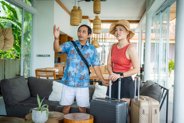 istock Local Guide Explains Villa Facilities to East Asian Tourists 2165496007