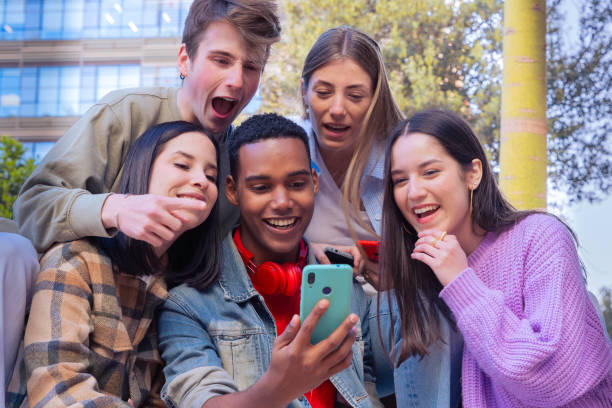 istock Students having fun with mobile phones creating content on social media. 2165496087