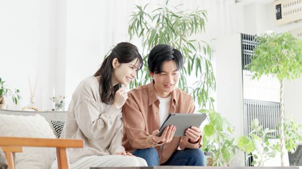 istock Couples browsing real estate and travel sites 2165501730