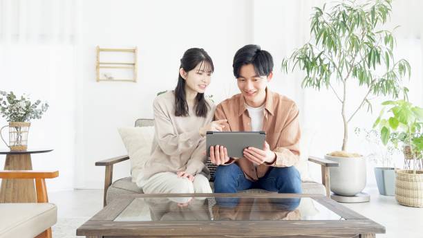 istock Couples browsing real estate and travel sites 2165501731