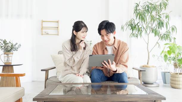 istock Couples browsing real estate and travel sites 2165501733
