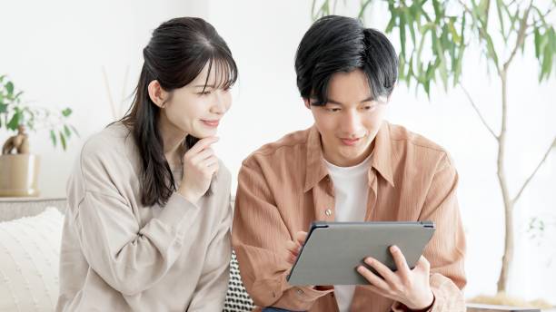 istock Couples browsing real estate and travel sites 2165501737
