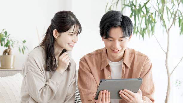 istock Couples browsing real estate and travel sites 2165501740