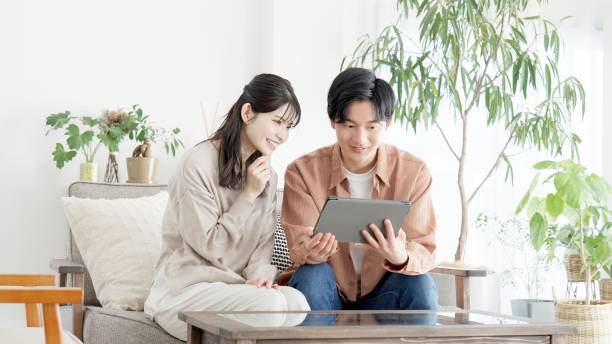 istock Couples browsing real estate and travel sites 2165501743