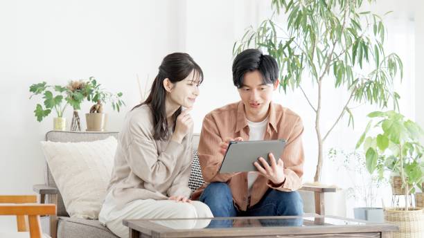 istock Couples browsing real estate and travel sites 2165501746