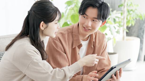 istock Couples browsing real estate and travel sites 2165501768