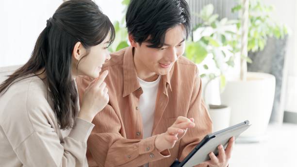 istock Couples browsing real estate and travel sites 2165501774