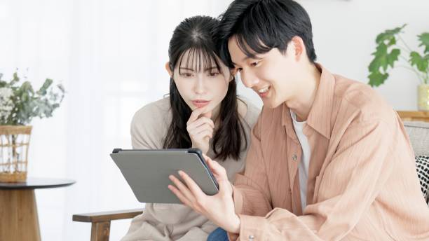 istock Couples browsing real estate and travel sites 2165501811