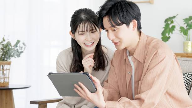 istock Couples browsing real estate and travel sites 2165501822