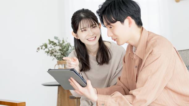 istock Couples browsing real estate and travel sites 2165501831