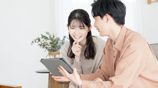 istock Couples browsing real estate and travel sites 2165501839
