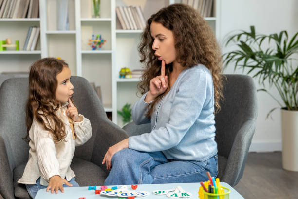 istock Speech therapist working with a girl and both looking involved 2165510115