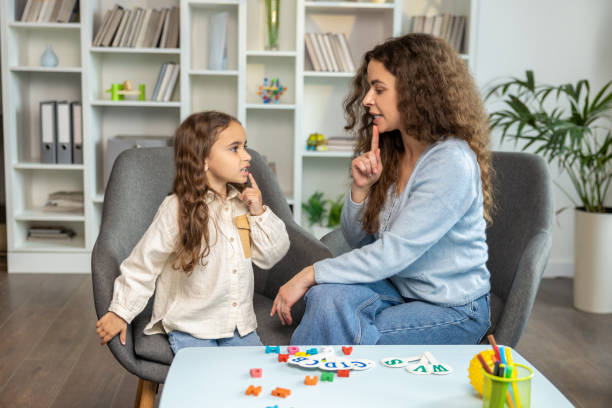 istock Speech therapist working with a girl and both looking involved 2165510126