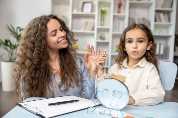 istock Child and doctor working on articulation and looking contented and concentrated 2165510201