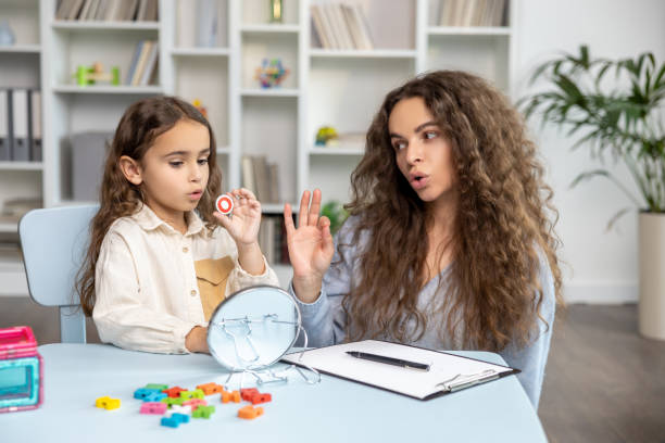 istock Child and doctor working on articulation and looking contented and concentrated 2165510202