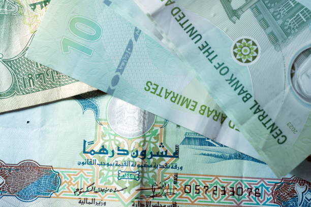 istock Close up Dirhams currency, AED, Bank note and coins, United Arab Emirates 2165510595