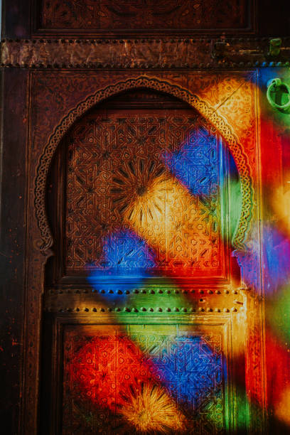 Wooden slat ceiling painted with traditional Moroccan motifs.