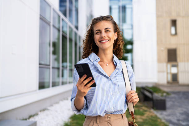istock Businesswoman using mobile phone while leaving from the office 2165512052