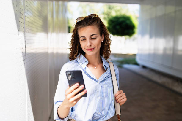 istock Businesswoman using mobile phone while leaving from the office 2165512128