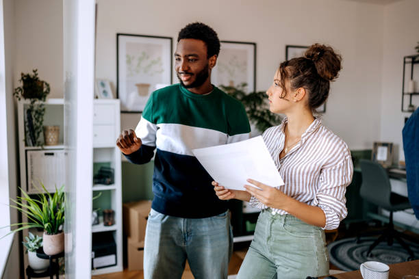 istock Two young casually clothed colleagues talking near whiteboard at the office 2165512295