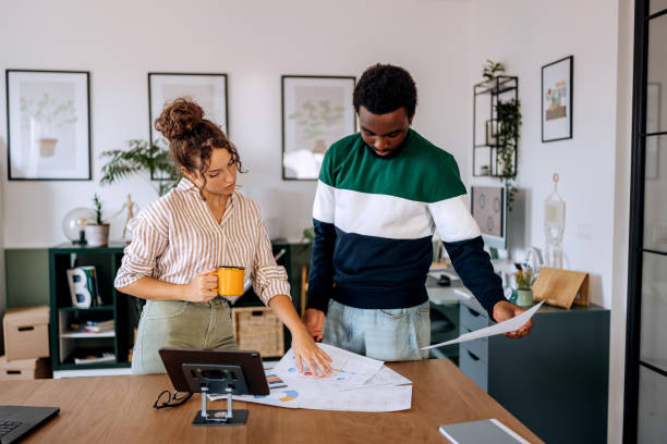 istock Two casually clothed young colleagues cooperating at the modern office 2165512352