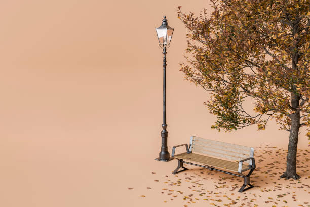 Park bench and vintage lamp post beside an autumn tree with fallen leaves on a peach background. Concept of autumn season and outdoor relaxation. 3d rendering