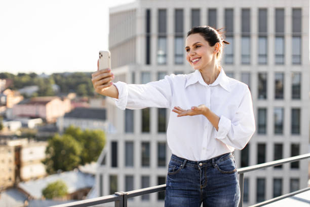 istock Woman taking selfie on balcony in urban environment 2165512651