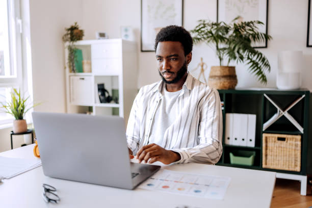 istock Young casually clothed businessman using laptop at the modern office 2165512662