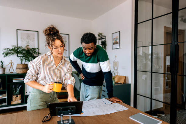 istock Young colleagues going over paperwork at the office 2165512821