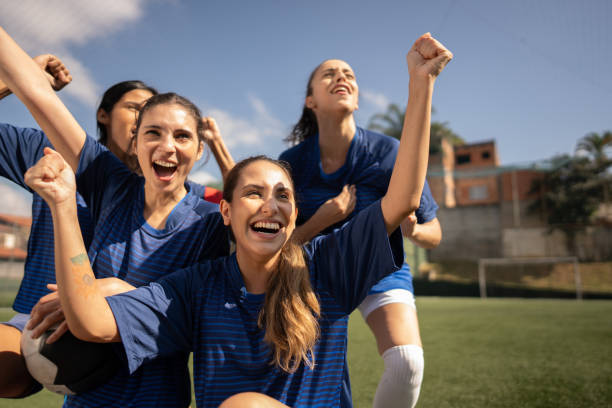 istock Soccer players celebrating on soccer field 2165513751