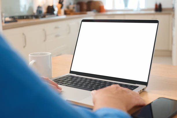 istock Person Working on Blank Laptop in Bright Kitchen During Daylight Hours 2165515266