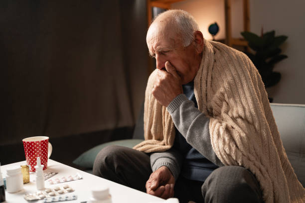 istock Ill sick middle aged man cough caught cold got flu influenza taking medications at home alone 2165515970