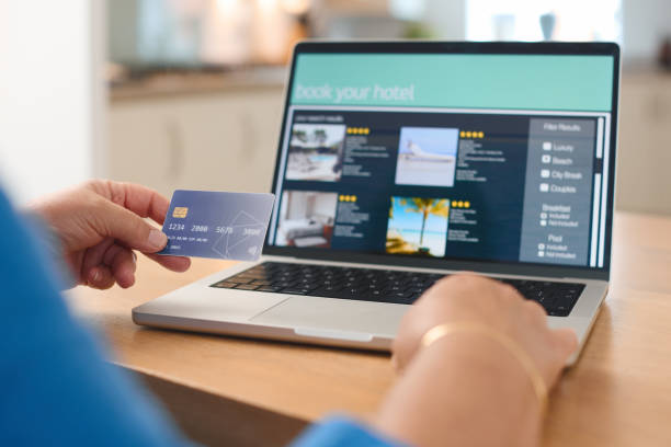 istock Booking A Vacation Rental Online Using A Credit Card At Home 2165516081