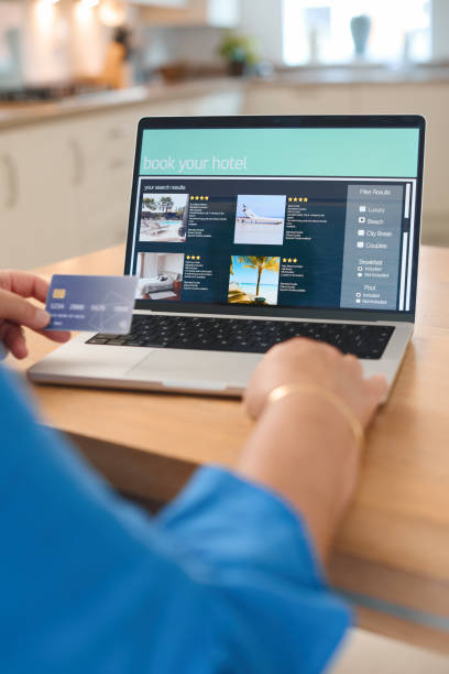 istock Booking a Hotel Online With a Credit Card in a Modern Kitchen 2165516128