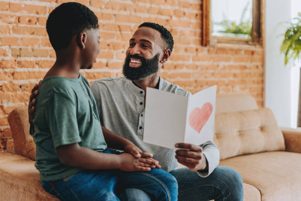 istock Son gives father a postcard on Father's Day 2165517275