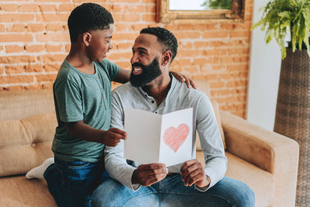 istock Son gives father a postcard on Father's Day 2165517277