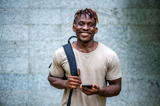 istock Smiling Black Man Enjoying Smartphone Interaction 2165519214