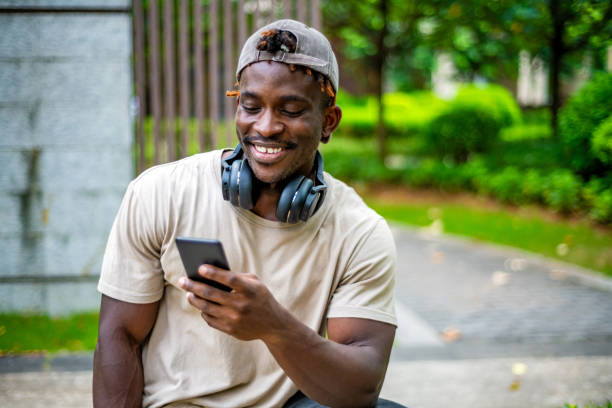 istock Joyful Black Man Using Smartphone Outdoors 2165519236