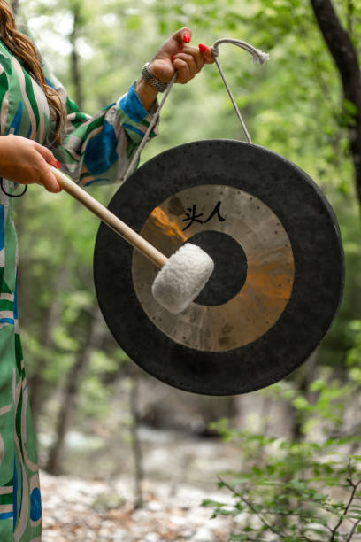 istock Woman Using A Gong For A Music Therapy In Nature 2165519634