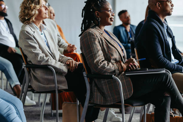 istock Professionals focused on presentation at business meeting with diverse audience 2165519753