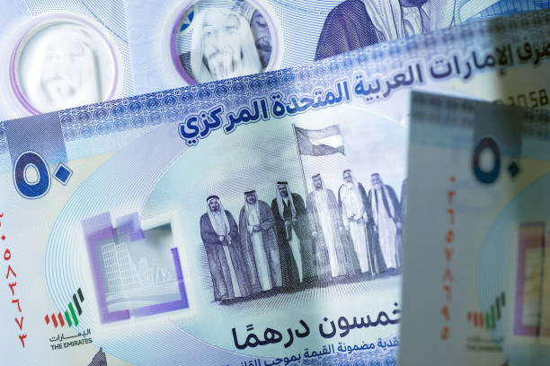 istock Close up Dirhams currency, AED, Bank note and coins, United Arab Emirates 2165521640