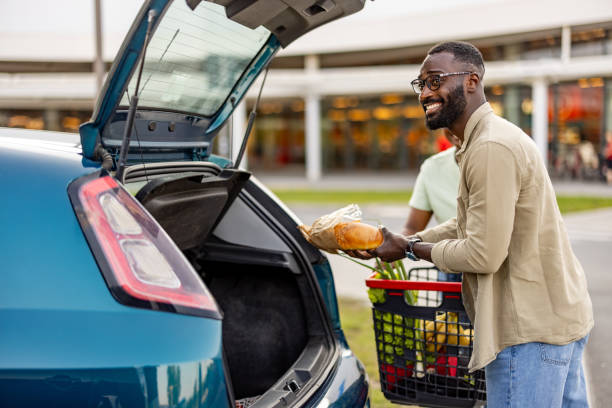 istock Joyful Couple Loading Groceries After Shopping 2165522190
