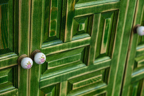 The green wooden door exudes a sense of tranquility and harmony, blending seamlessly with its natural surroundings while adding a touch of rustic elegance and timeless charm to the space it graces.