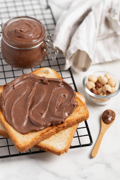 istock fresh toasts with chocolate paste and berries serve on table for delicious breakfast 2165524324