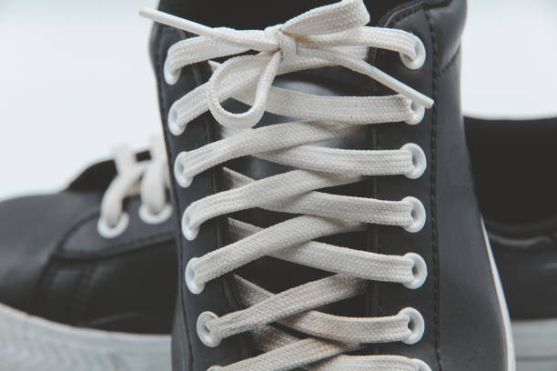 shoe sneaker on white background, close up of sneaker on white background, old black generic sneakers on white background.