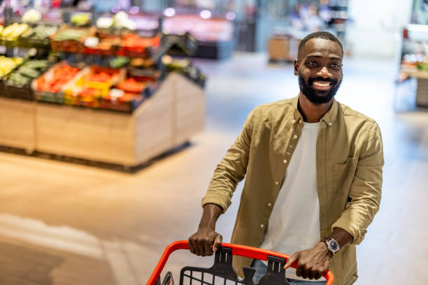 istock Cheerful Black Man Shopping in Grocery Store 2165526773