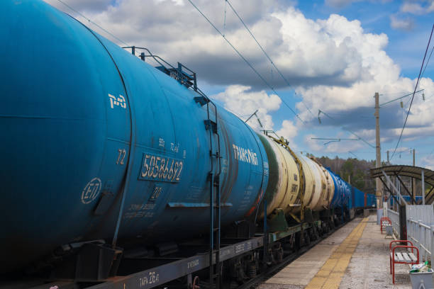 Kryuchkovo, Krasnoyarsk railway, Russia - May 11, 2024: Freight train with petroleum tank-cars on empty railway platform. Oil gasoline diesel fuel in railway tank cars. Railway shipping industry