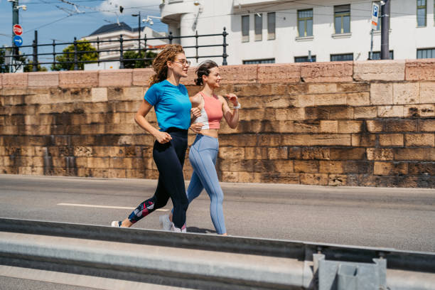 istock Two Female Friends Running Outdoors In Budapest In Hungary 2165529367